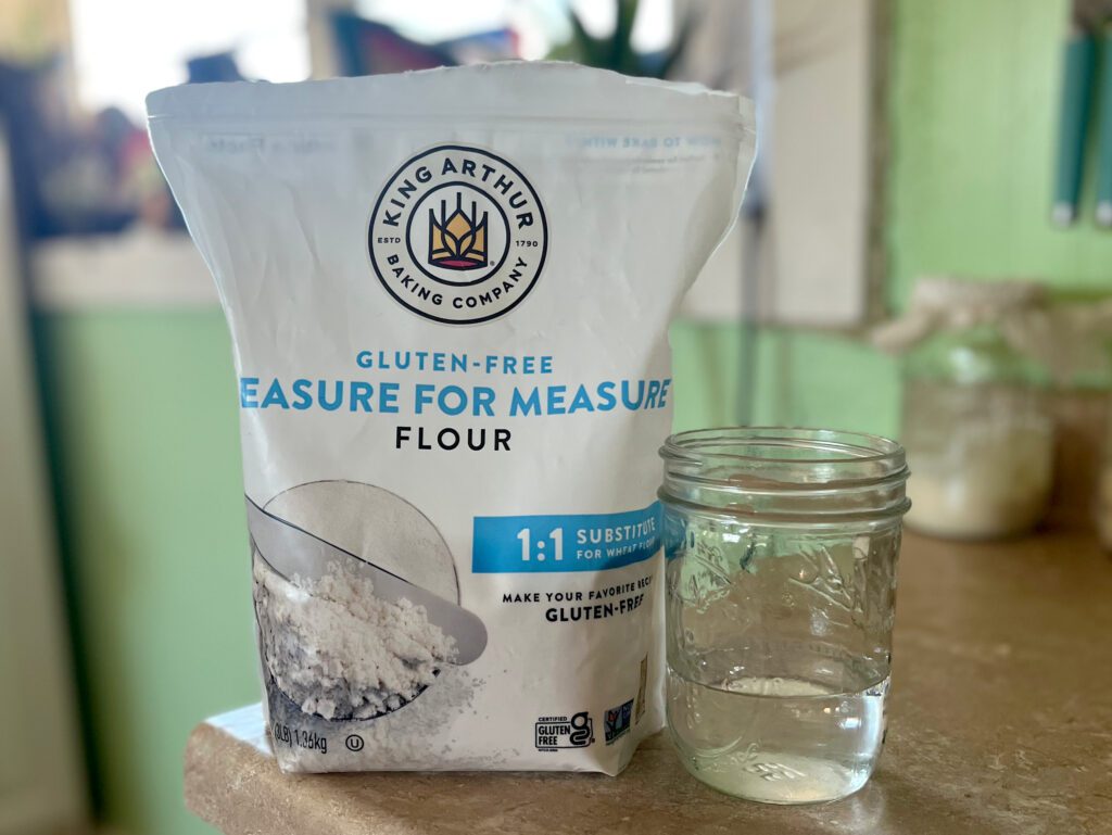 gluten free flour and glass of water sitting on the counter