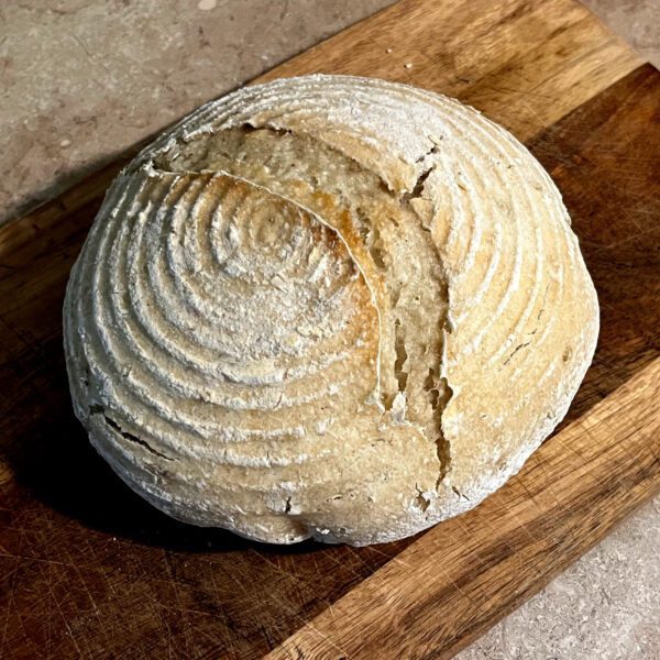 gluten free loaf of sourdough sitting on a cutting board