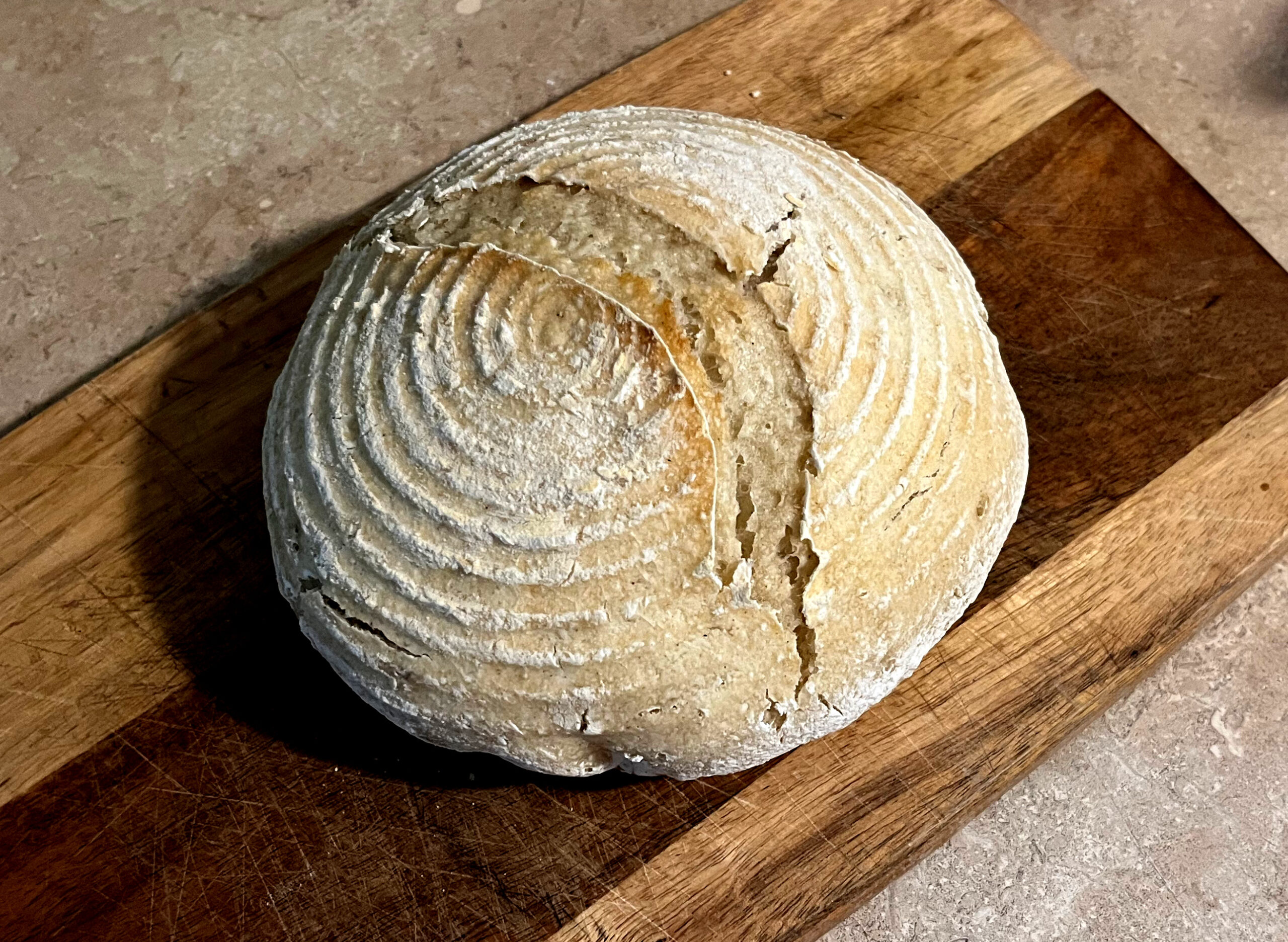 gluten free loaf of sourdough sitting on a cutting board