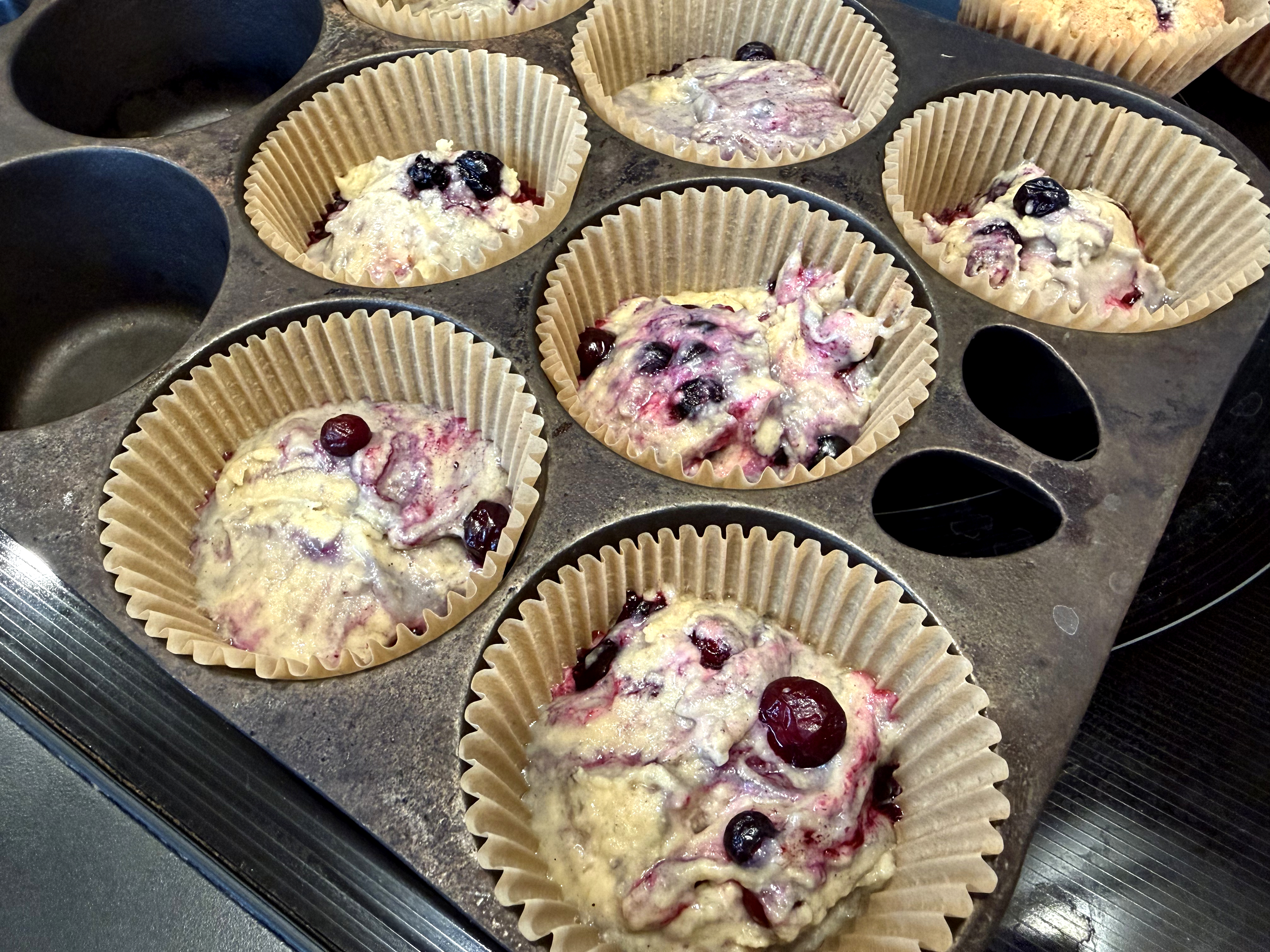 raw muffin batter in muffin pan

