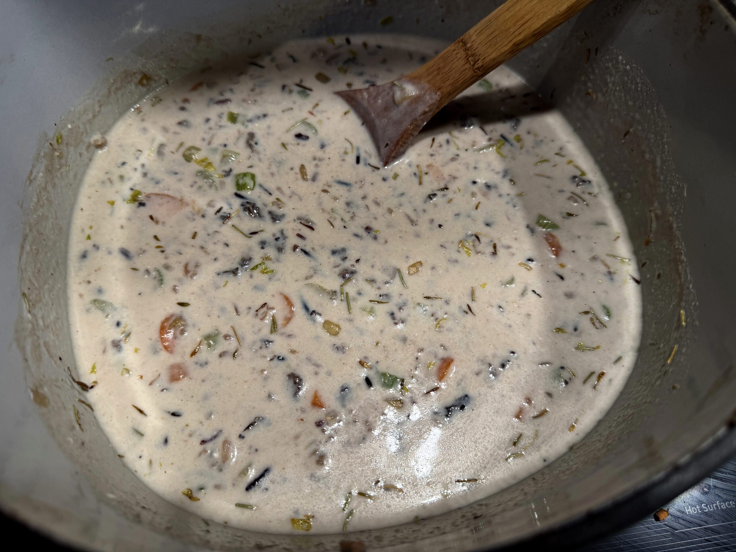 creamy wild rice and mushroom soup on the stove