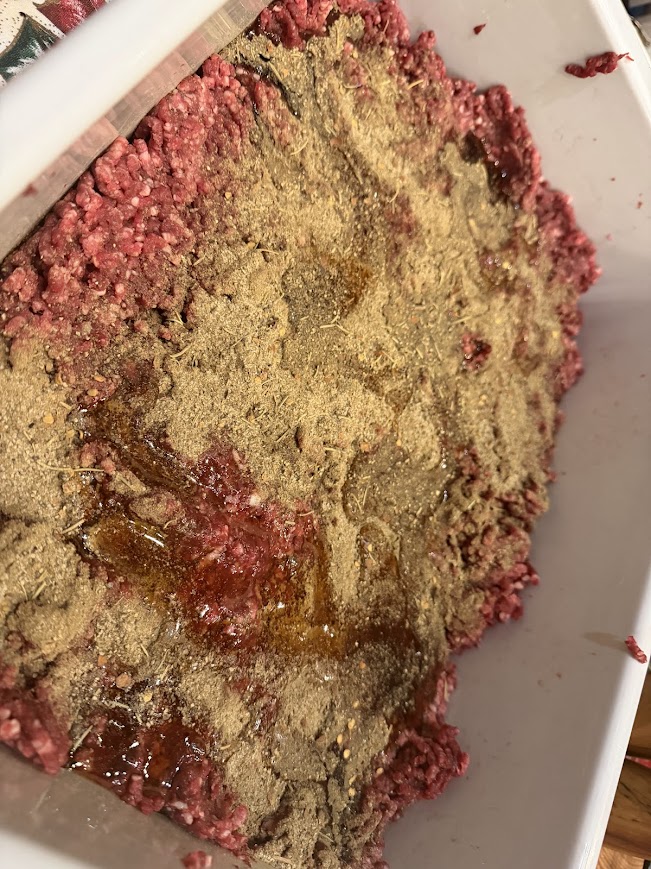 meat in tub with seasonings