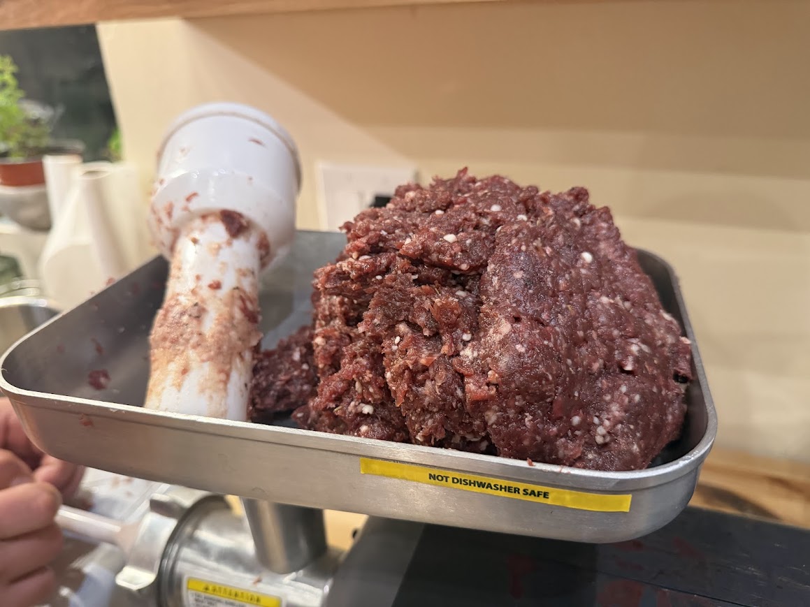 meat in tray of meat grinder